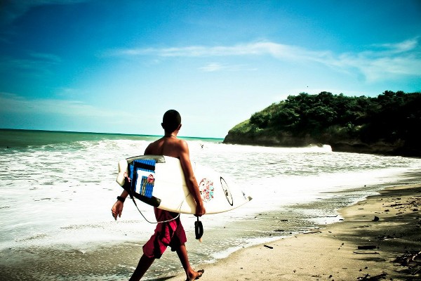 Surfer walking on Playa el Palmar 